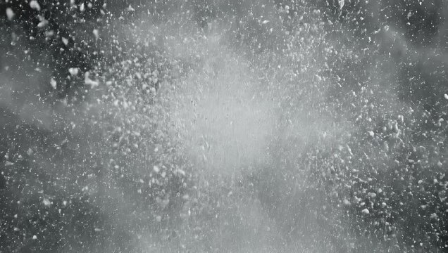 White powder exploding outwards against a dark black background