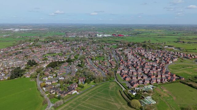 Aerial drone view of the historic town of Tutbury and close-up detail of a modern new build residential suburb development in Staffordshire, UK.
