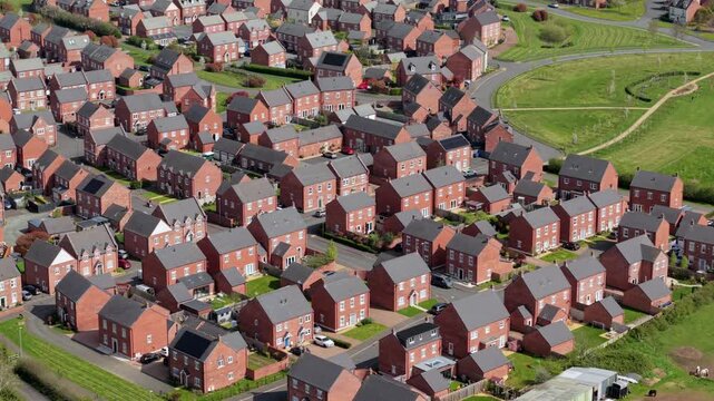Aerial drone view of new build residential houses and the historic town of Tutbury in Staffordshire UK