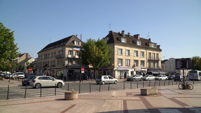 Historic town center of Creil in northern France under a clear blue sky.