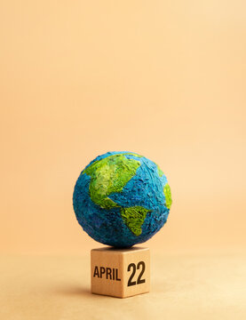 Globe on wooden block marked April 22 representing Earth Day awareness