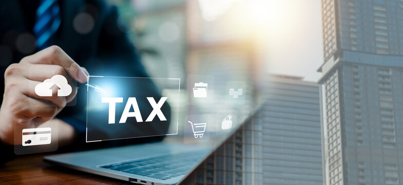 Business professional using laptop with virtual tax interface and cloud technology, digital finance icons, online payment, banking, and data management. Concept of fintech, taxation.