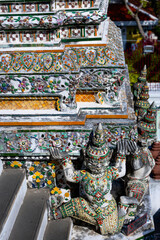 Fototapeta premium Colorful mosaic guardian statues on ornate temple wall