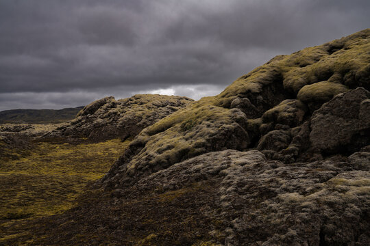 View of moss-covered volcanic rocks under a stormy sky create a scene of stark beauty and isolation, Skaftarhreppur, Skaftarhreppur, Iceland.