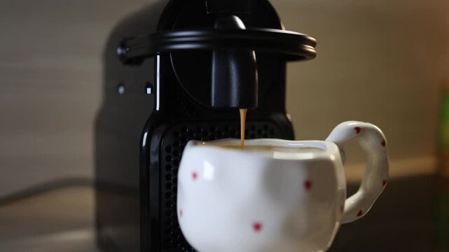 Coffee machine pouring drink into cup everyday routine energy boost beverage preparation workday start caffeine lifestyle concept