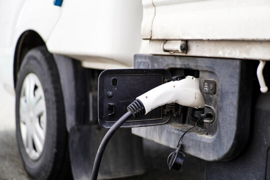 Electric Vehicle Charging Cable Plugged into a White Commercial Van