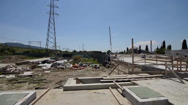 Exterior of construction site with cranes, scaffolding, and building under development