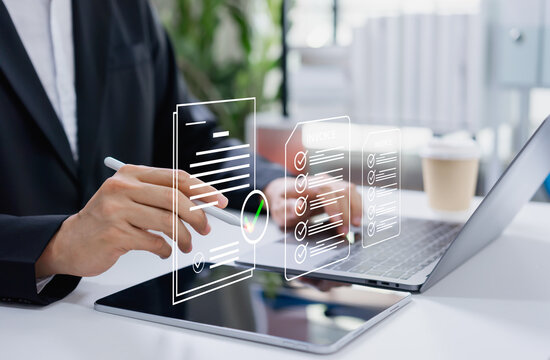 Businessman approving digital invoice on tablet and laptop, paperless billing system, e invoice management, and efficient online finance workflow.