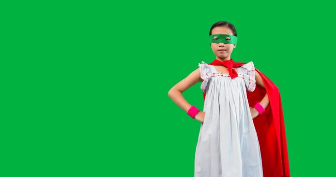 Asian girl wearing a superhero costume with hands on hips against black background