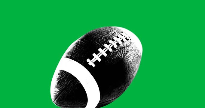 Close up view of a rugby ball against black background