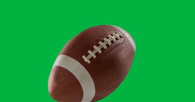 Close up view of a rugby ball against black background