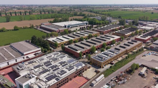 Aerial view of an integrated industrial supply chain network in Milan, Italy. Multi sector zone combining manufacturing, logistics, food production and energy infrastructure.