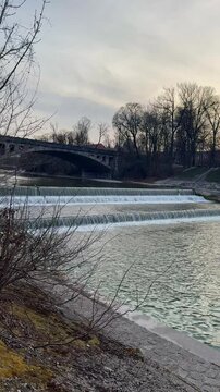 Dam with strong river flow and visible bridge structure