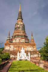 Fototapeta premium Ancient Wat Yai Chai Mongkhon temple with stupa and Buddha statues in Ayutthaya, Thailand