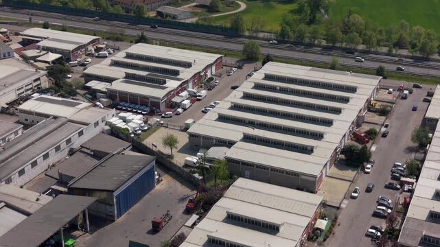 Drone aerial of an advanced manufacturing and logistics system in Milan, Italy. Industrial zone with automated production, packaging facilities and integrated supply chain operations.