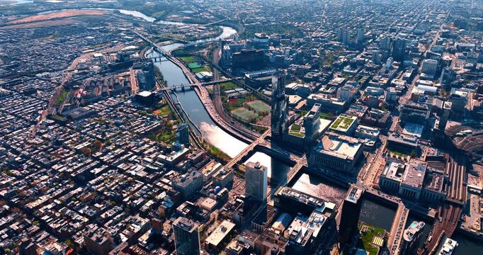 Approaching the narrow river winding through Center City, Philadelphia. Drone flight over developed area situated between the Schuylkill and the Delaware rivers.