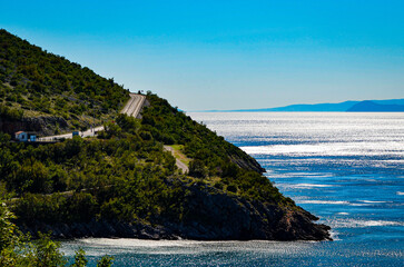 Fototapeta premium Coastal road along the Adriatic Sea in Croatia with scenic mountain landscape, summer travel and road trip concept