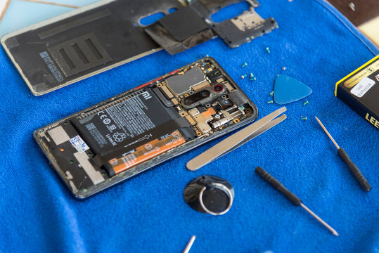 Nakhonpathom,Thailand - 20 March, 2026: Replacing old battery with Leeplus battery in Redmi K20 Pro smartphone on a repair desk.  