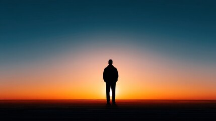 Fototapeta premium Silhouette of a Person Standing Alone Against a Vibrant Sunset Sky with Deep Orange and Blue Gradient Colors Creating a Serene Atmosphere of Contemplation