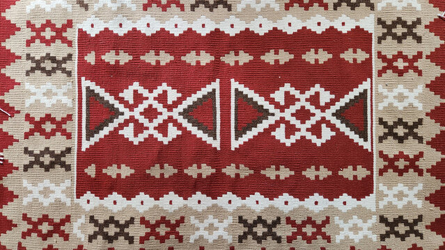A Turkish Kilim rug traditionally handwoven using wool or cotton yarns. A flat-woven rug made with a knotless weaving technique.