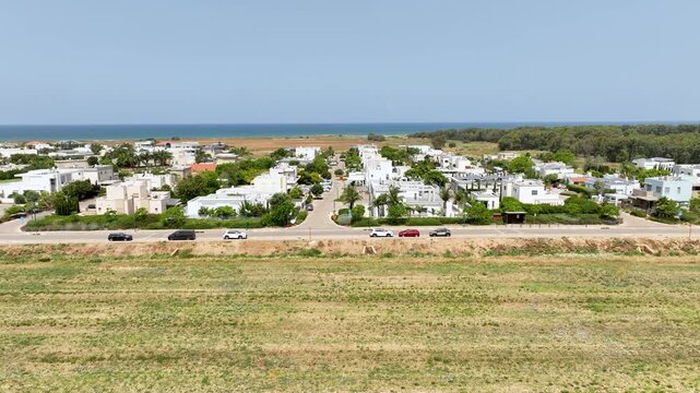Aerial view of houses and green fields in Bustan HaGalil by the Mediterranean Sea coast