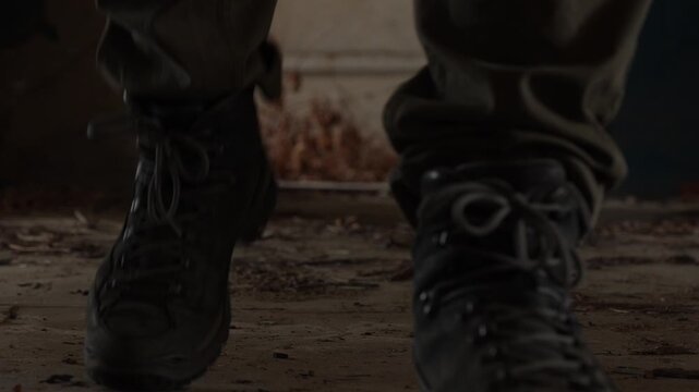 Close Up Low Angle View of Person in Tactical Boots and Cargo Pants Walking Through Abandoned Building