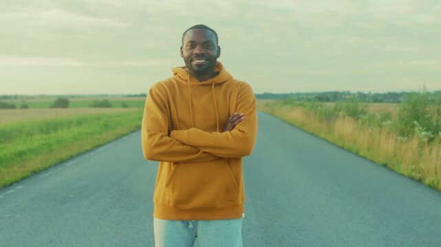 Young man with calm resilience, Serene image of poised man standing confidently on vacant rural highway