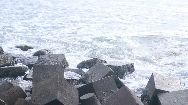 Concrete sea breakwaters that form a coastal breakwater protection at Glagah Beach, Yogyakarta.