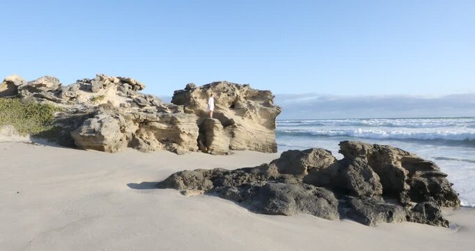 teenage girl overlooking beautiful rocky coastline, Sopies Klip, Hermanus, South Africa
