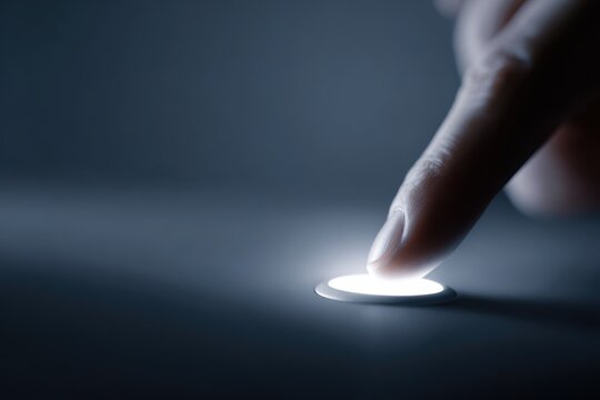 A person hand touching a glowing Start button, beginning of a journey