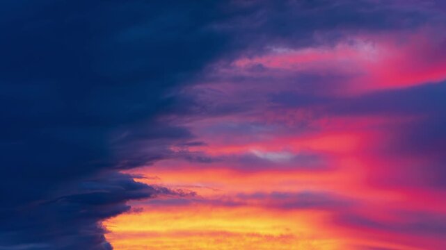 Abstract colorful sunset sky with smooth slow motion. Warm glowing clouds with soft gradient in orange, pink and blue. Perfect for backgrounds, branding, advertising, presentations and modern digital 