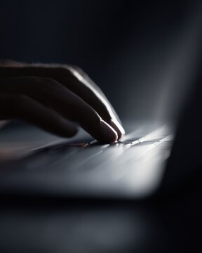 Hands using a touchpad on a high-end laptop, macro photography