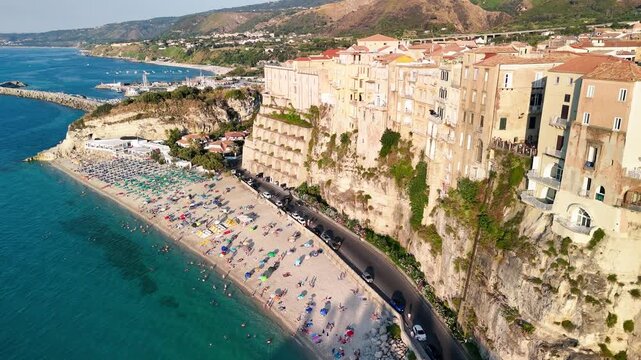 Dramatic aerial view of Tropea Calabria coastline and historic city from drone perspective