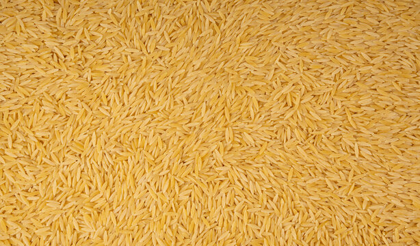 Raw orzo pasta, risoni or kritharaki pile