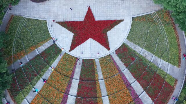 Bird's Eye View of Visitors Strolling and Admiring Flowers in a City Park