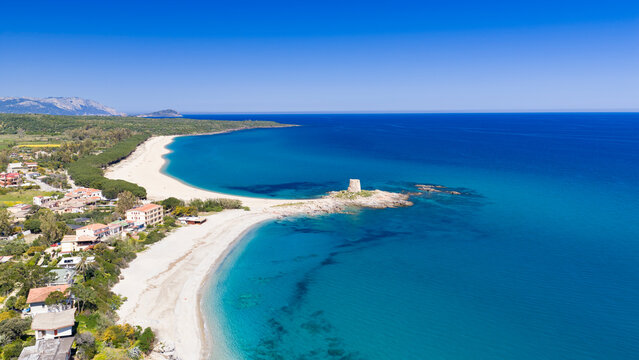 Aerial drone view of Torre di Bari, surrounded by turquoise waters and white sandy beaches along the eastern coast of Sardinia on a clear sunny day