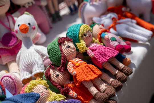 Handmade Colorful Amigurumi Dolls Displayed at Market Stall