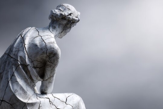 Cracked statue representing broken freedom concept