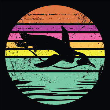 Swimming Penguin - Silhouette diving in water with vintage retro sunset backdrop