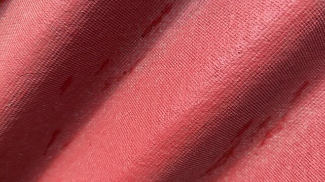 Closeup red corrugated roof texture showing sunlit waves, subtle paint stains, fabric like grain and shadowed ridges, roofer.