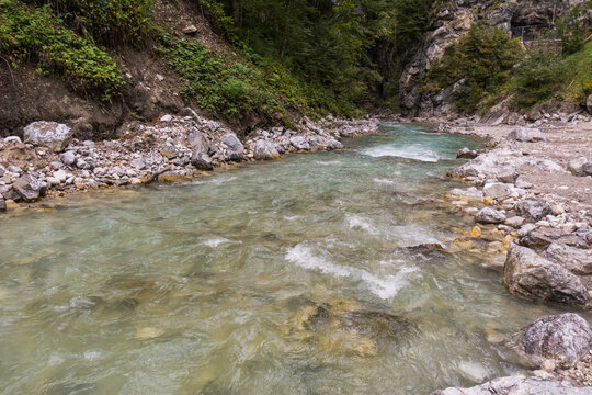 Turquoise river flowing through a wide scenic rocky mountain valley near Garmisch-Partenkirchen, Bavaria, Partnach Klamm
