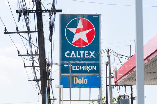 Phuket Thailand 30 11 2025: Caltex gas station sign with Techron and Delo branding, fuel company billboard and power lines in urban street, petroleum industry and energy concept, editorial use