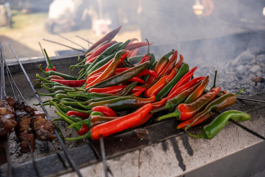 Grilled Red and Green Chili Peppers on Barbecue with Smoke