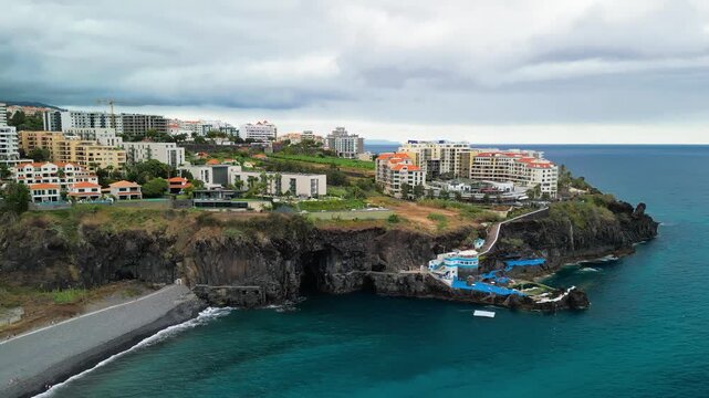 Aerial summer view of Doca do Cavacas in Madeira, capturing turquoise waters, moored boats, and vibrant coastal scenery