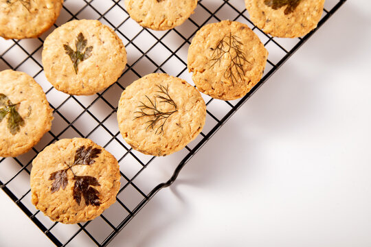 Herb-infused parmesan cookies cooling on wire rack