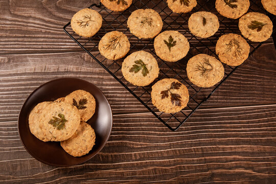 Herb shortbread cookies with parmesan on cooling rack