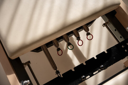 Close-up of Pilates reformer springs in modern studio
