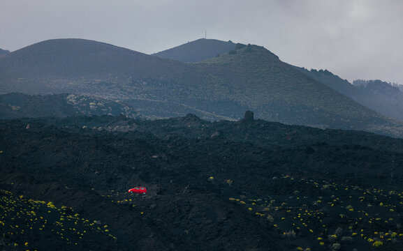 Volcanic landscape of La Palma with lone red car