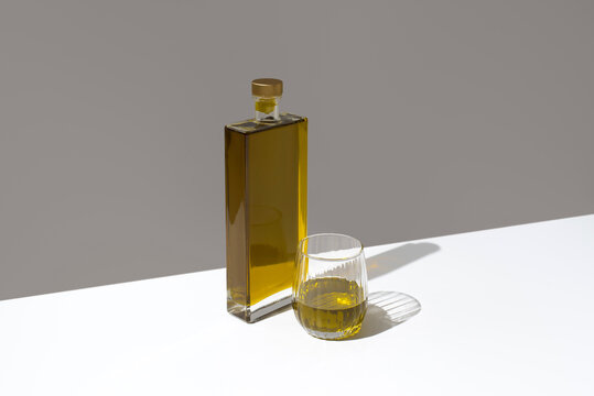 Minimal olive oil tasting setup with bottle and glass