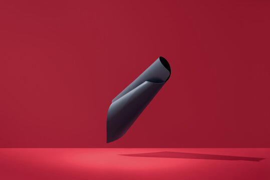Curved abstract black 3D shape floating on red background
